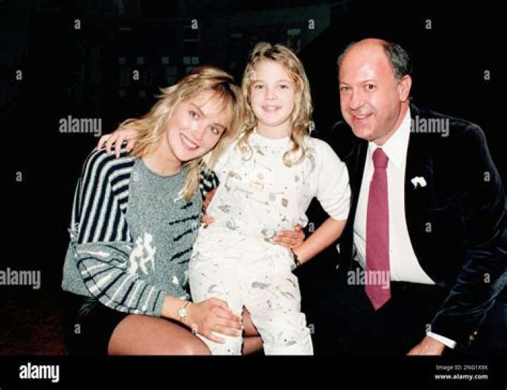 Actress Drew Barrymore, center, with Sharon Stone, at left, and Allen Garfield at Hollywood screening of "Irreconcilable Differences" on September 24, 1984. (AP Photo/Scott Harms)