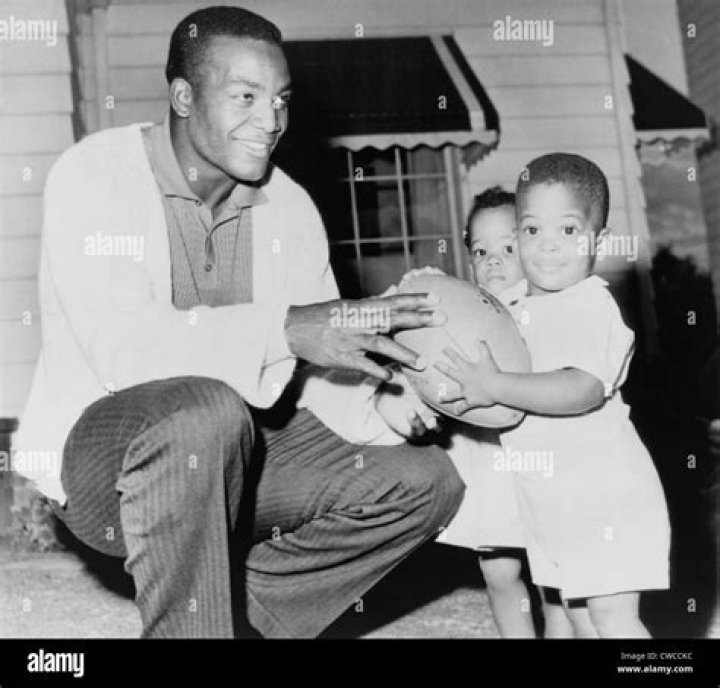 Jim Brown, at the beginning of his professional football career with his twins, Kevin and Kim. Sept. 27, 1961.Historical Collection