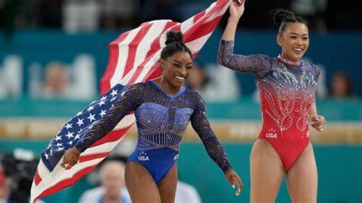 Simone Biles walks to her gate for her flight to the Summer Olympic Games in Tokyo as United Airlines employees wave flags during a send-off event for the U.S. Women's Gymnastics team at the San Francisco International Airport on US Gymnastics Biles, San Francisco, United States - 14 Jul 2021